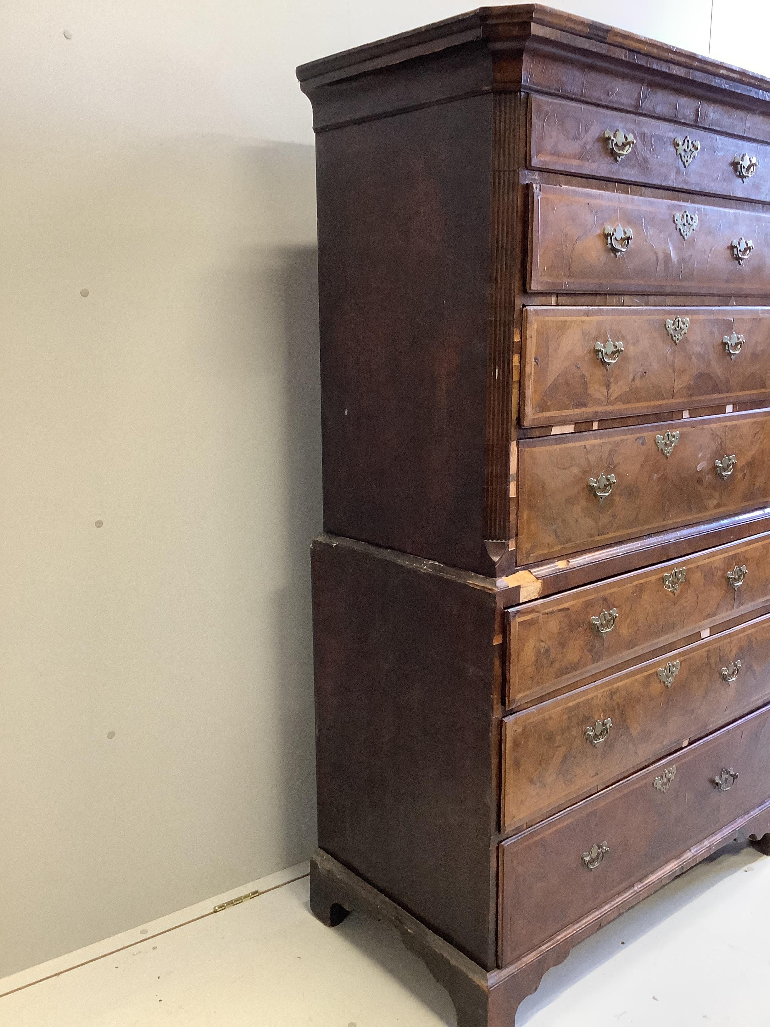 An 18th century feather banded walnut chest on chest, width 101cm, depth 52cm, height 173cm